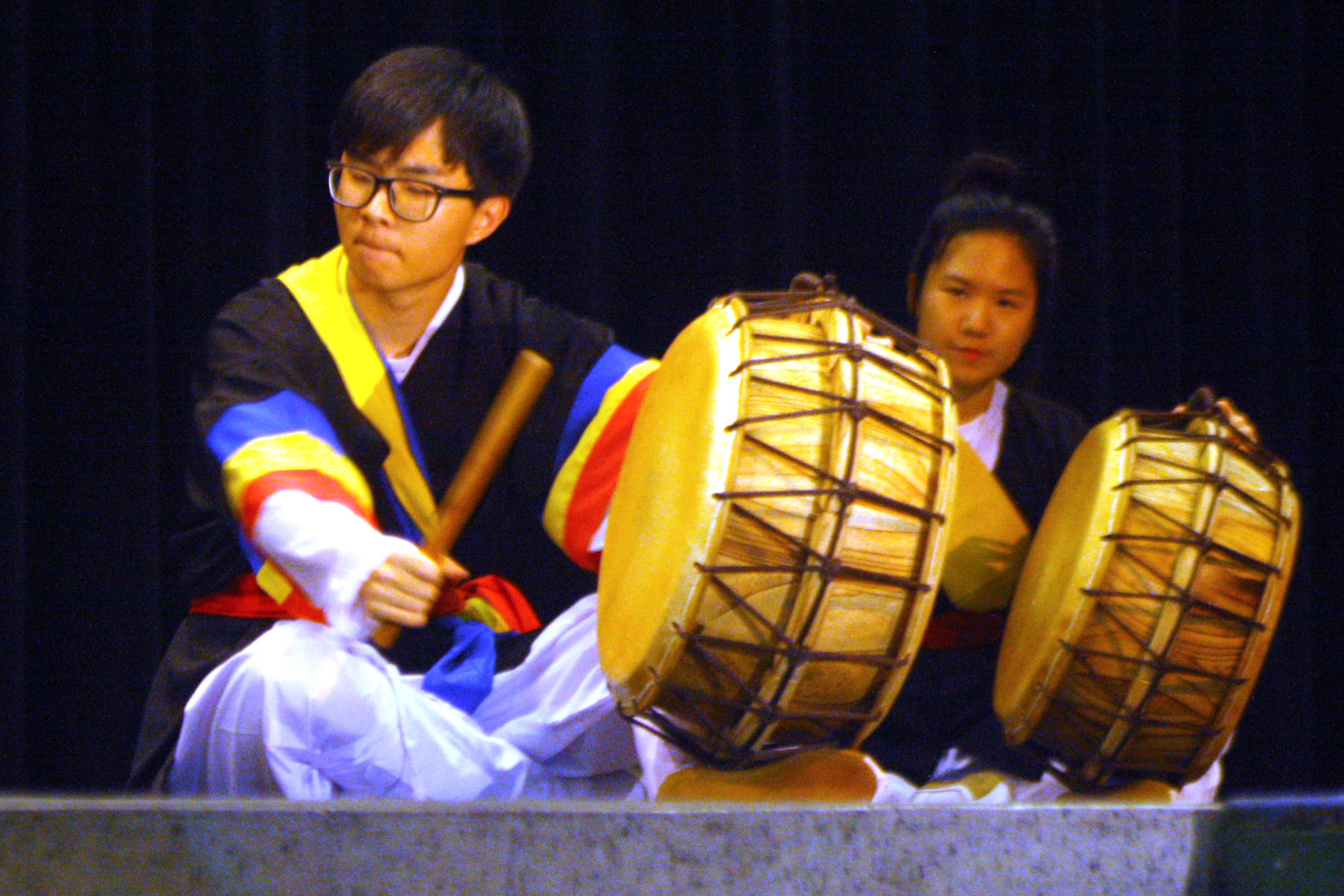 At the 2016 Culture Fair, senior Derek Jang and junior Sharon Park play traditional Korean drums with the group called Daool, which means