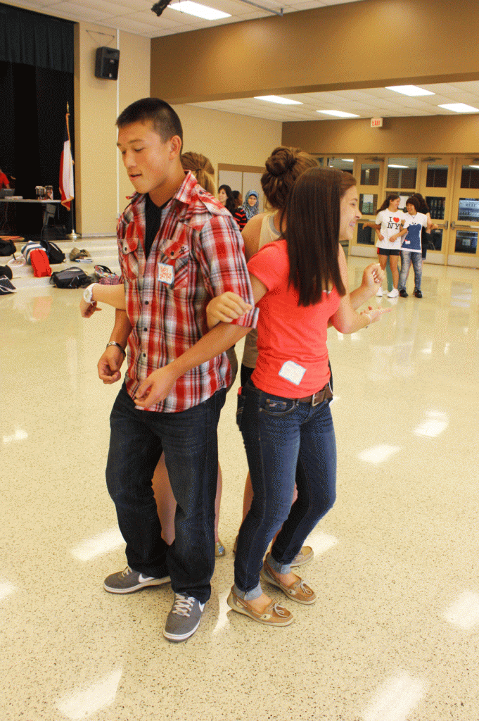 Linking arms with Valerie LaFuente (11), Senior Kody Steele dances to music for a game at the Ice Cream Social hosted by Student Council. Having moved from Seattle, Washington, Steele met other new students from Kentucky, Louisiana, and Oregon at this newcomer’s event. “It was really awkward because I didn’t know anybody at this school,” Steele said. “But after this event, I feel a lot more comfortable with people at McNeil.”

Photo By : Marissa Byrd
