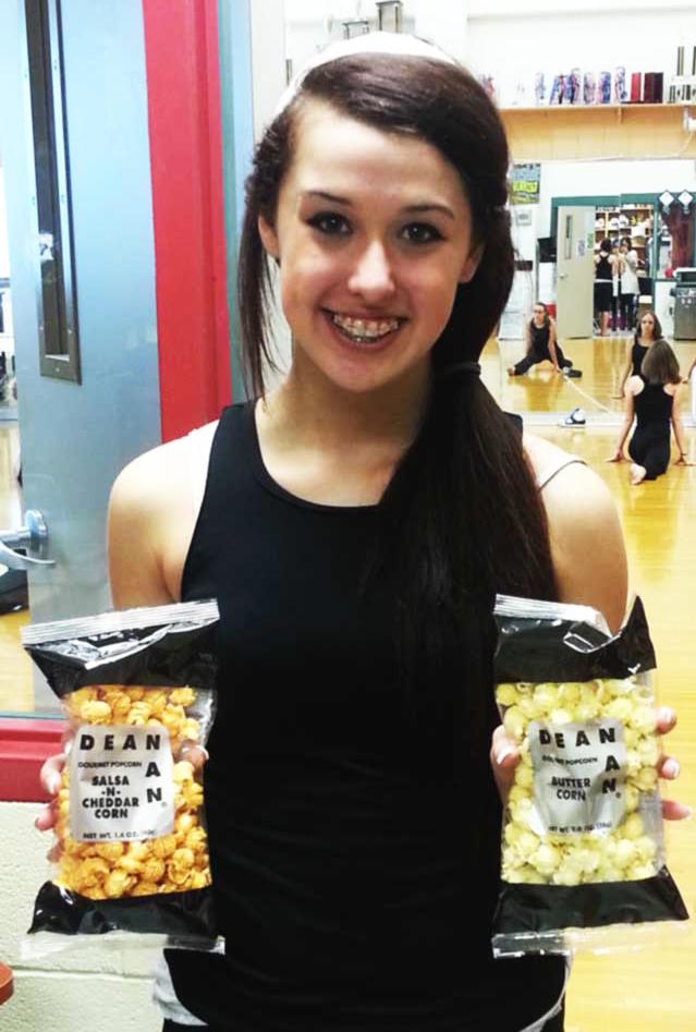 Sapphire Dancer Megan Whittaker shows off the limited popcorn bags that are now on sale. The dancers are selling many varieties of popcorn for competitions and to pay for the costumes. “It’s been really fun selling popcorn,” Whittaker said. “They’re good, fresh and something to buy.” 