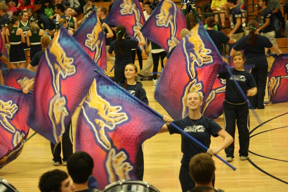 The colorguard performs the fight song at a pep rally. These same girls (and boy) will be on the winterguard teams.