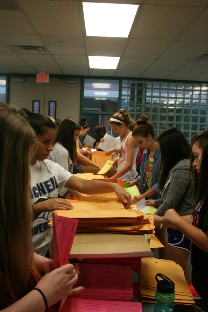 The cheer team putting together the first day of school packets. 