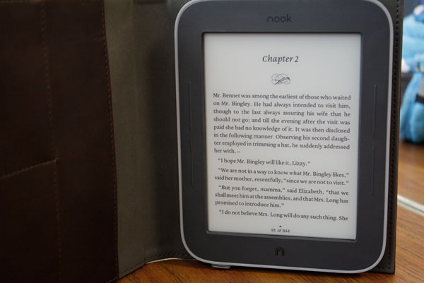 A Nook Simple Touch opened to Chapter 2 of Pride and Prejudice by Jane Austen. 