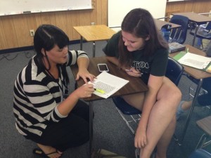 Latin teacher Keely Drummonds helps Kailyn Brush with her assignment.