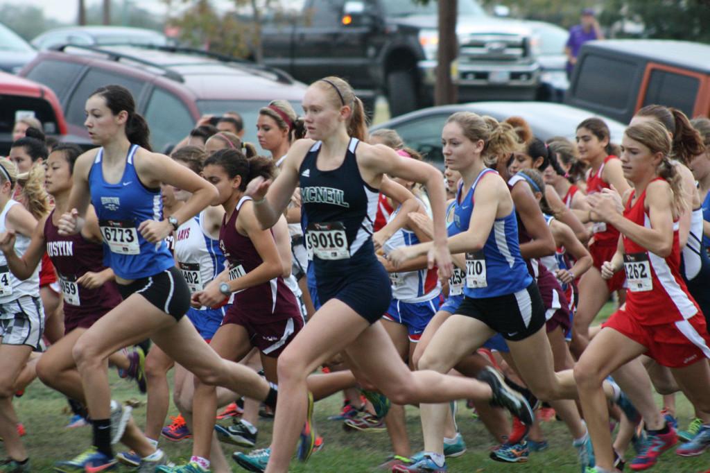 Varsity Cross Country girls race to finish line in October meet.