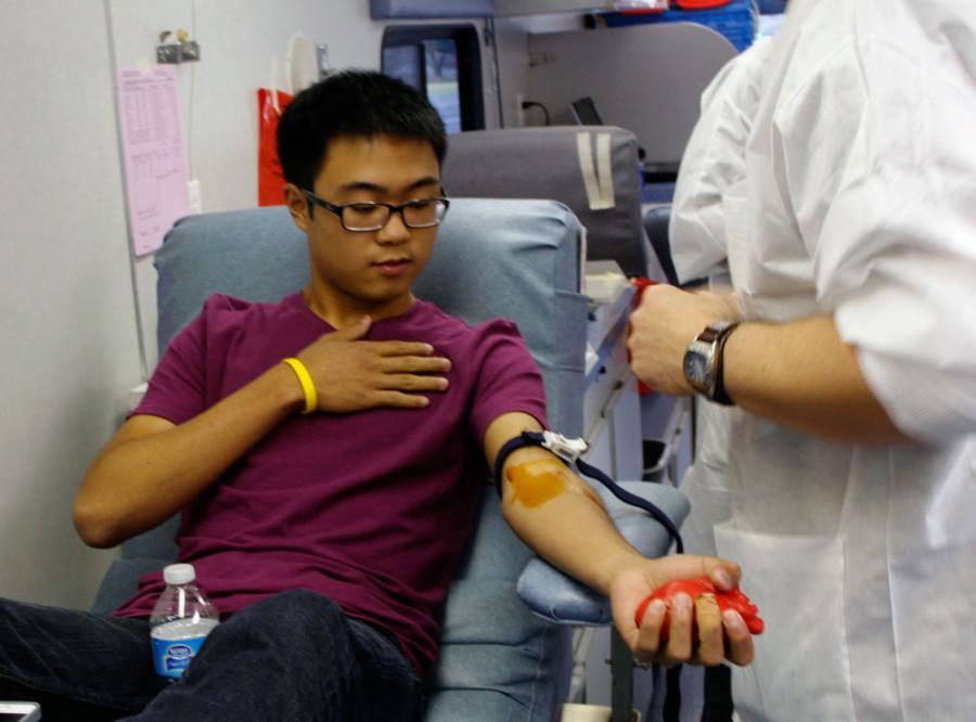 Edward Sun preparing to donate blood