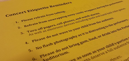 These rules of audience etiquette posted on a middle school orchestra program is applicable to all school performances. 