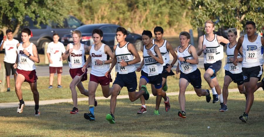 At the district 6A meet, varsity boys kick off to the sound of the gun