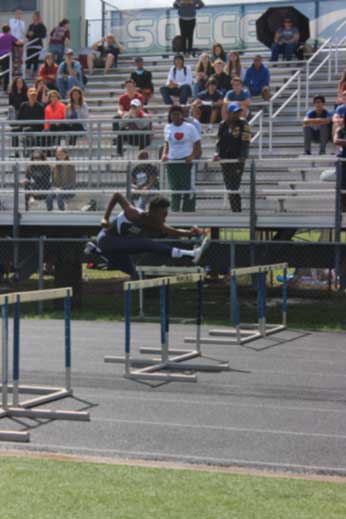 Faith Tormusa (10) clears a hurdle in the 100 meter hurdle race. She is one of the nine members of the girls track team who advanced to Regionals.