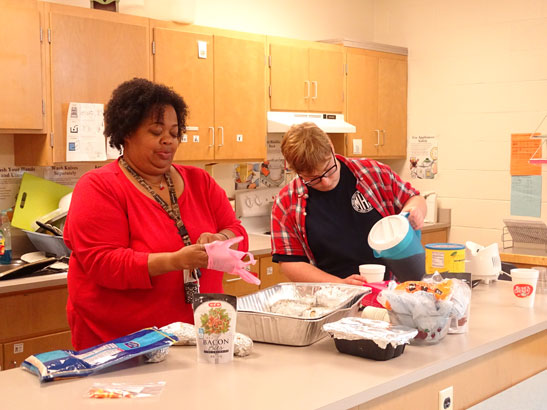 Joyace Pugh and Gabe Allumbaugh prepare to cook.