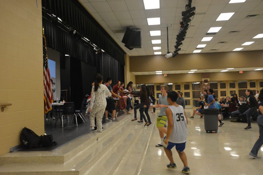 Competitors race to the National Honor Society officers with their responses to a trivia question.