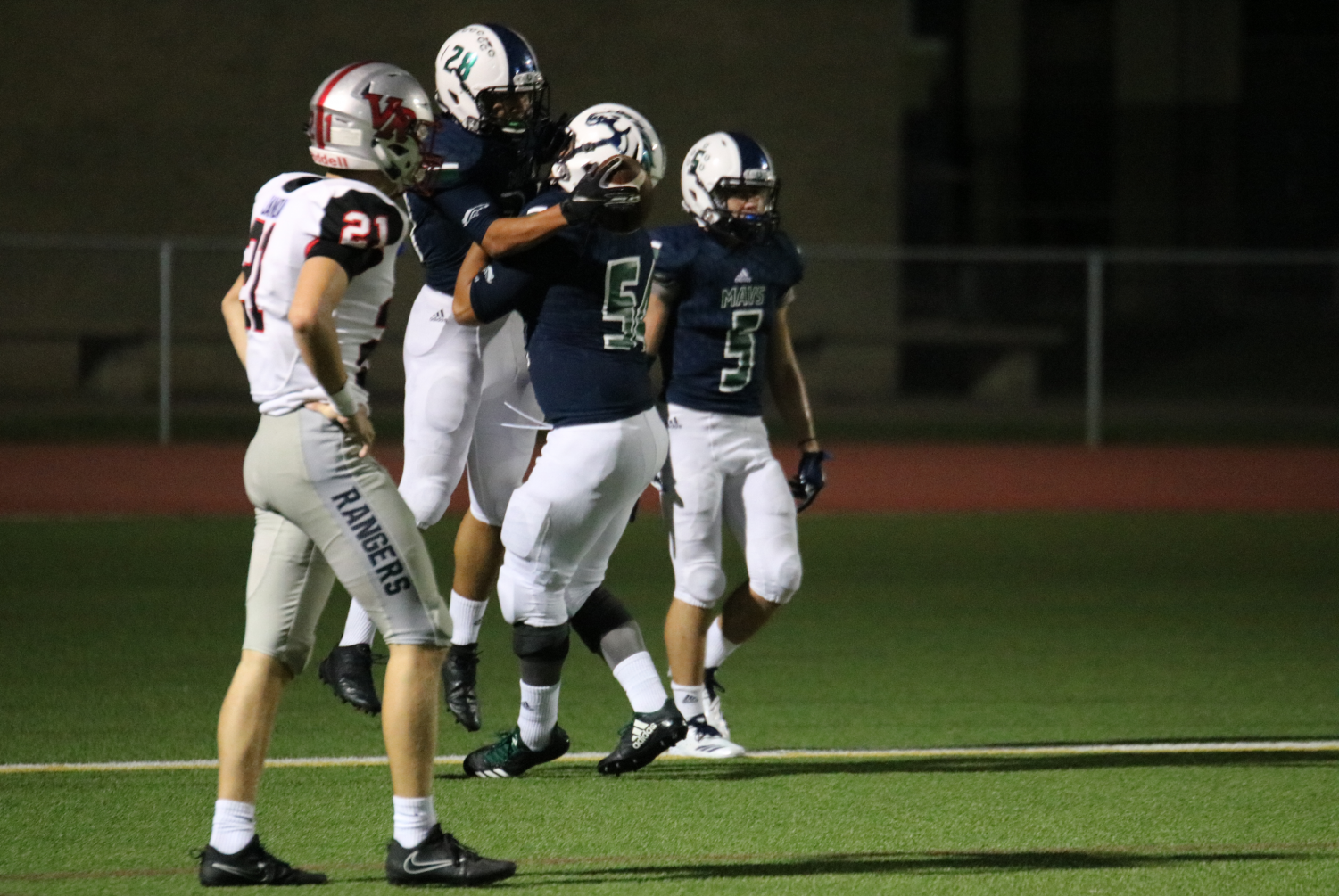 After punching in a touchdown, junior running back Winston Hutchison (#28) celebrates with senior offensive lineman Deinkhanh Tran (#54) in the endzone. The Mavs clinched their first district win over the Vista Ridge Rangers 49-21 at Dragon Stadium Sept. 14.