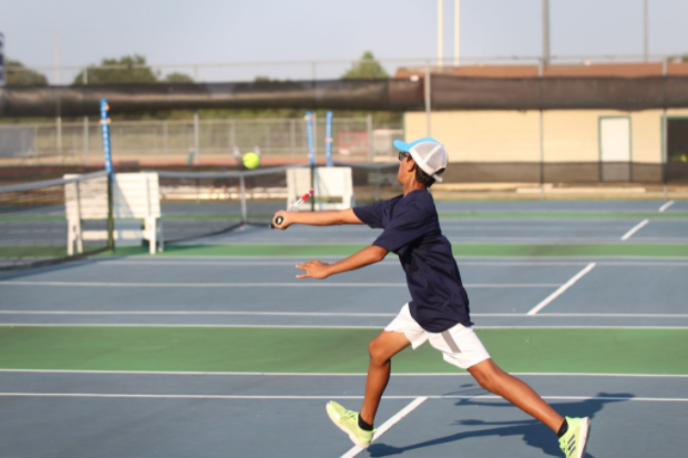 Shaunak Gadgil volleys at the service line against Hutto at the match on Thursday.