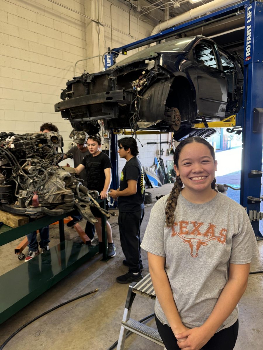 Automotive students preparing car smash van in class, Senior Arianna Braddy posed in front. 
