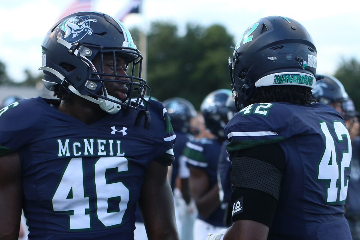 Junior Jacorian Hubbard, and Senior Nwadike Nwosu stand in passing from coming off the field. Hubbard said coming off the field was pretty overwhelming since he was trying to focus on what to do on and off the field, fitting alignments listening to the coaches, and being able to adapt to everything going on around him. 