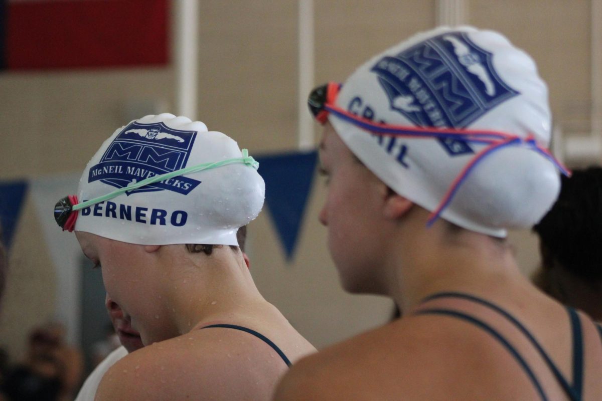 At their district opener meet, freshman Katherine Bernero and sophomore Addison Crail prepare for their event. 