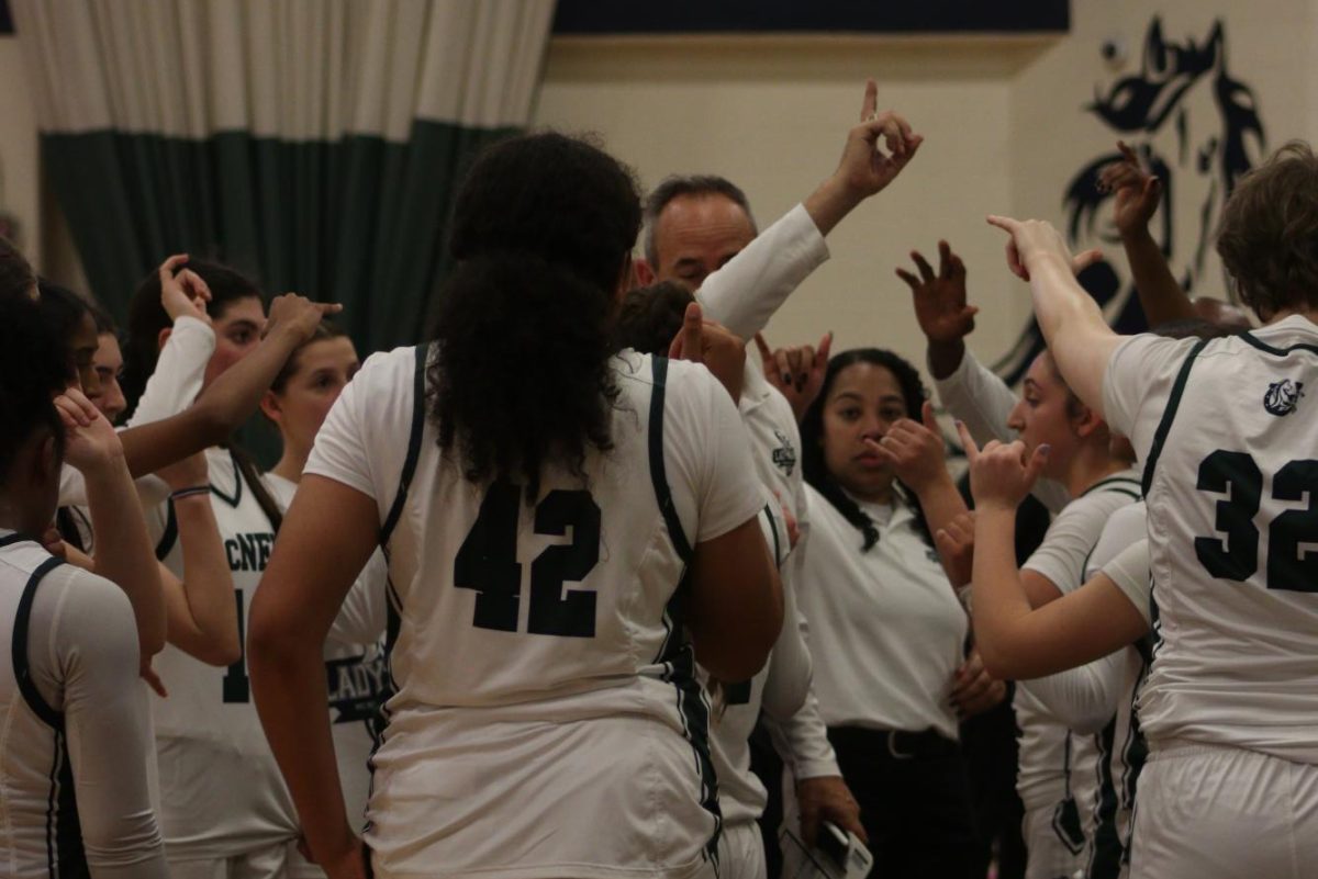 From their Nov. 5 game, the Lady Mavs huddle around head coach Matthew Butler.