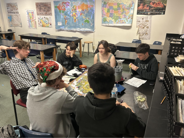 Students Roman Kerr, Dan Gerace, Nathaniel Hall, Johnny Nguyen, and Jerry Swenson listen to George McGilligan as he describes how a system in their D&D campaign works. 