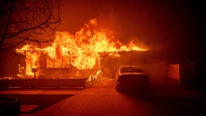 A house aflame in the Palisades neighborhood during the 2025 Los Angeles wildfires. (Photo: AP Photo/Ethan Swope)