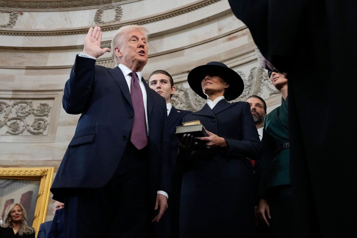 Donald Trump is sworn in as the 47th president of the United States by Chief Justice John Roberts as Melania Trump holds the Bible during the inauguration ceremony in the Capitol Rotunda on Monday, January 20. (Morry Gash / Pool / AFP / Getty Images)