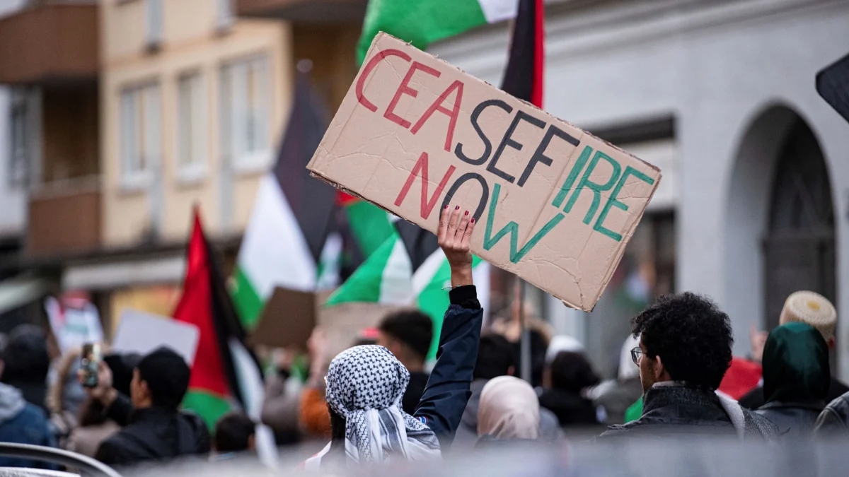 A protester holds a sign reading, “Ceasefire Now,” at a demonstration calling for an immediate cease-fire in the war in Gaza, in Munich, Germany, Nov. 11, 2023 (Sipa photo via AP Images).