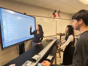 Senior Arturo Ramos, Junior Megan Nguyen, and Senior Shennie Ye performing the crumple zone lab in AP Physics. “We were figuring out how to use the vernier extension since that is how we would be able to calculate the force time and impulse. The lab was fun, simple, and good practice.”