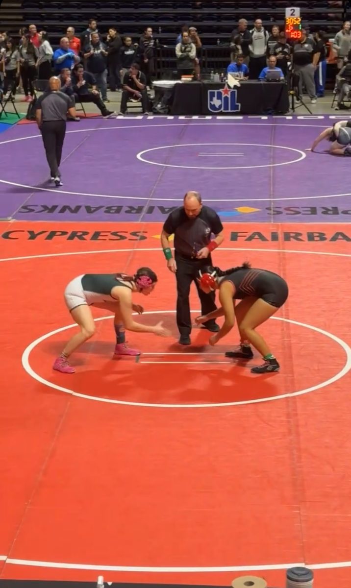 Standing on the starting line, Senior
Maxfield Rotches shakes the hand of
her opponent from Lake Highlands High
School before the referee blows the
starting whistle.