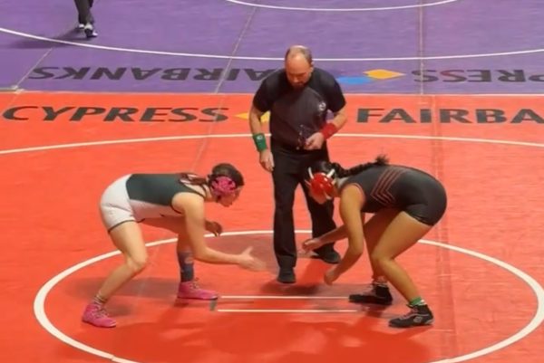 Standing on the starting line, Senior
Maxfield Rotches shakes the hand of
her opponent from Lake Highlands High
School before the referee blows the
starting whistle.