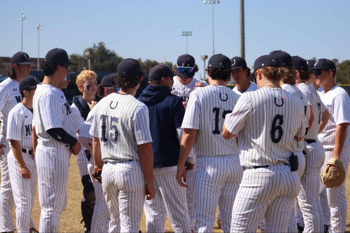 In an early season game against LASA High School, Coach Brad Croak talks to the team to establish a plan.
