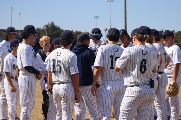 In an early season game against LASA High School, Coach Brad Croak talks to the team to establish a plan.