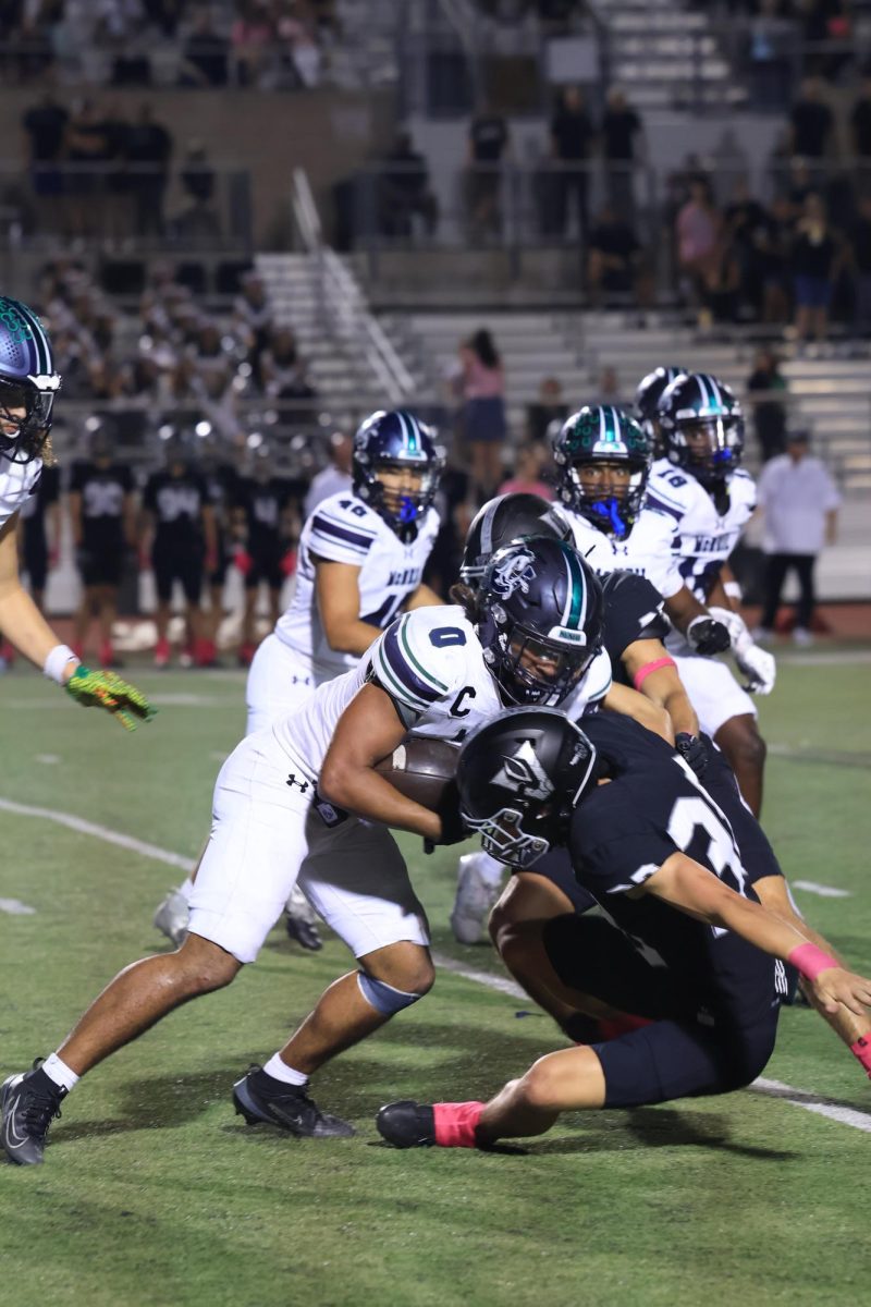 Senior Aden Taylor runs the ball, gaining yards leading up to the second touchdown of the game.