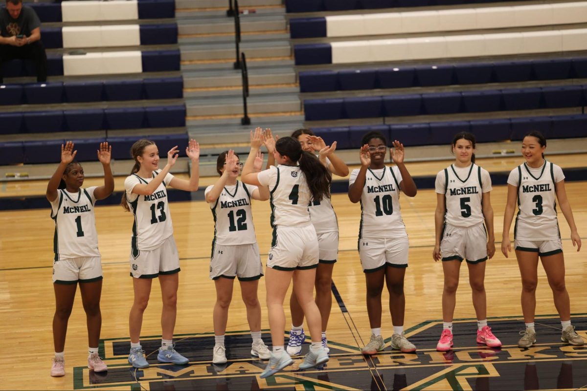 The Mavericks do their pregame ritual of player introductions prior to their game against Manor High School.