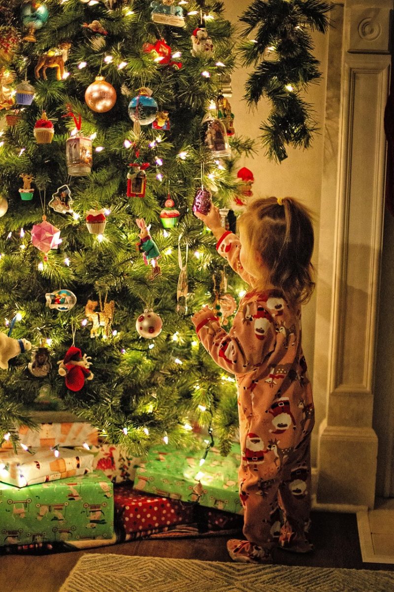 A child looks at ornaments on the Christmas tree. Photo Courtesy of Jill Wellington