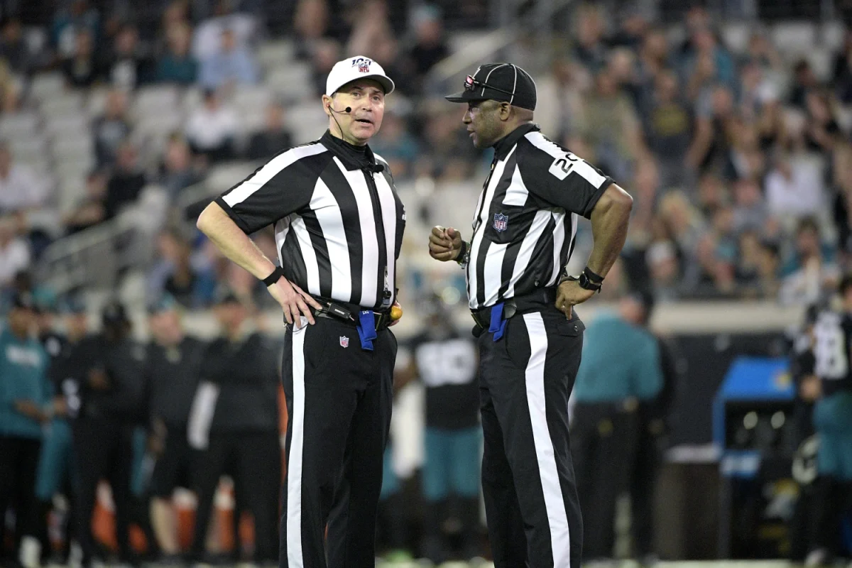 NFL officials talk on the field during the second half of a game. Photo Courtesy of NBC News