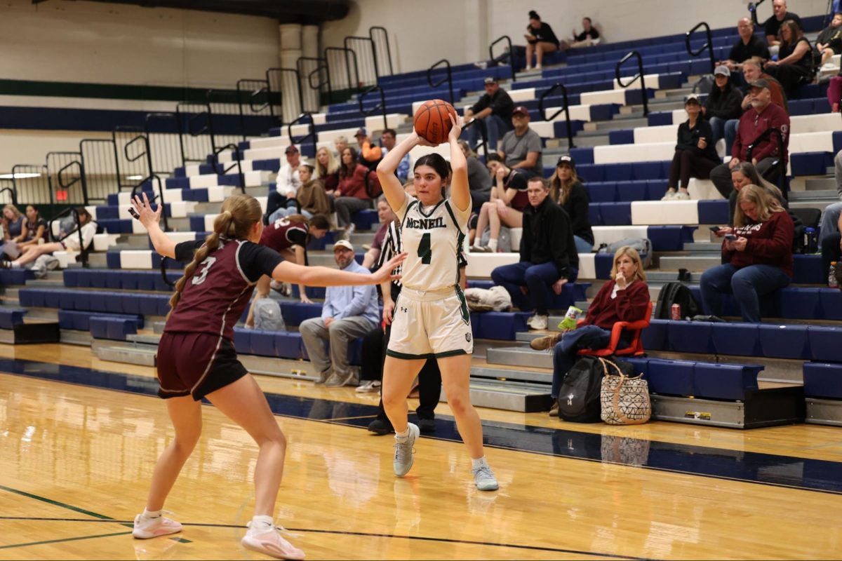 Senior Forward Lila Svoboda looking inside in an attempt to pass the ball into the post for a layup.
