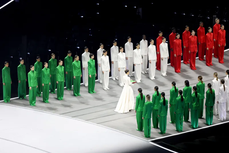 Model Vittoria Ceretti presents the Italian flag, bordered by models wearing the Italian tricolor. Photo Courtesy of Women's Wear Daily