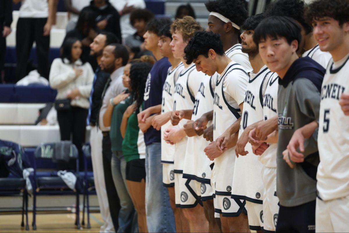 The Mavericks link arms during the national anthem before their game at home on Friday, Dec. 12, ending the game up 65-58, with the Mavericks bringing home their first district win of the season. 
