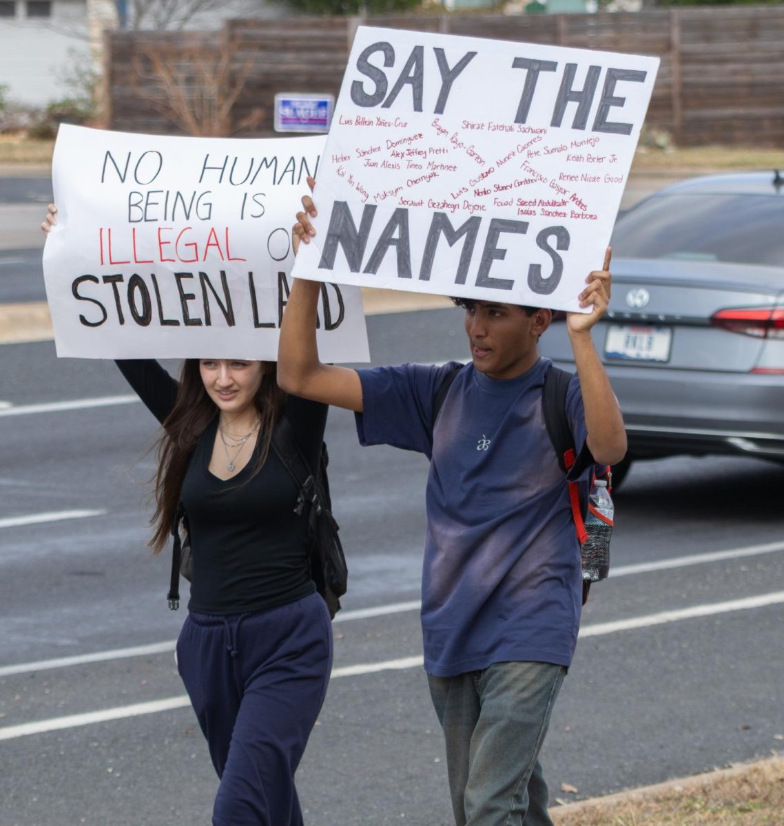 Protesters hold up signs during the 2/13 ICE walkout.