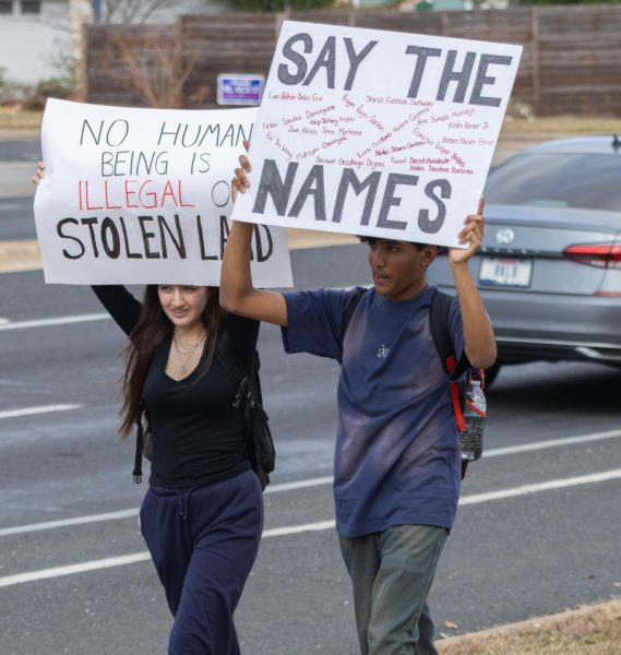 Protesters hold up signs during the 2/13 ICE walkout.