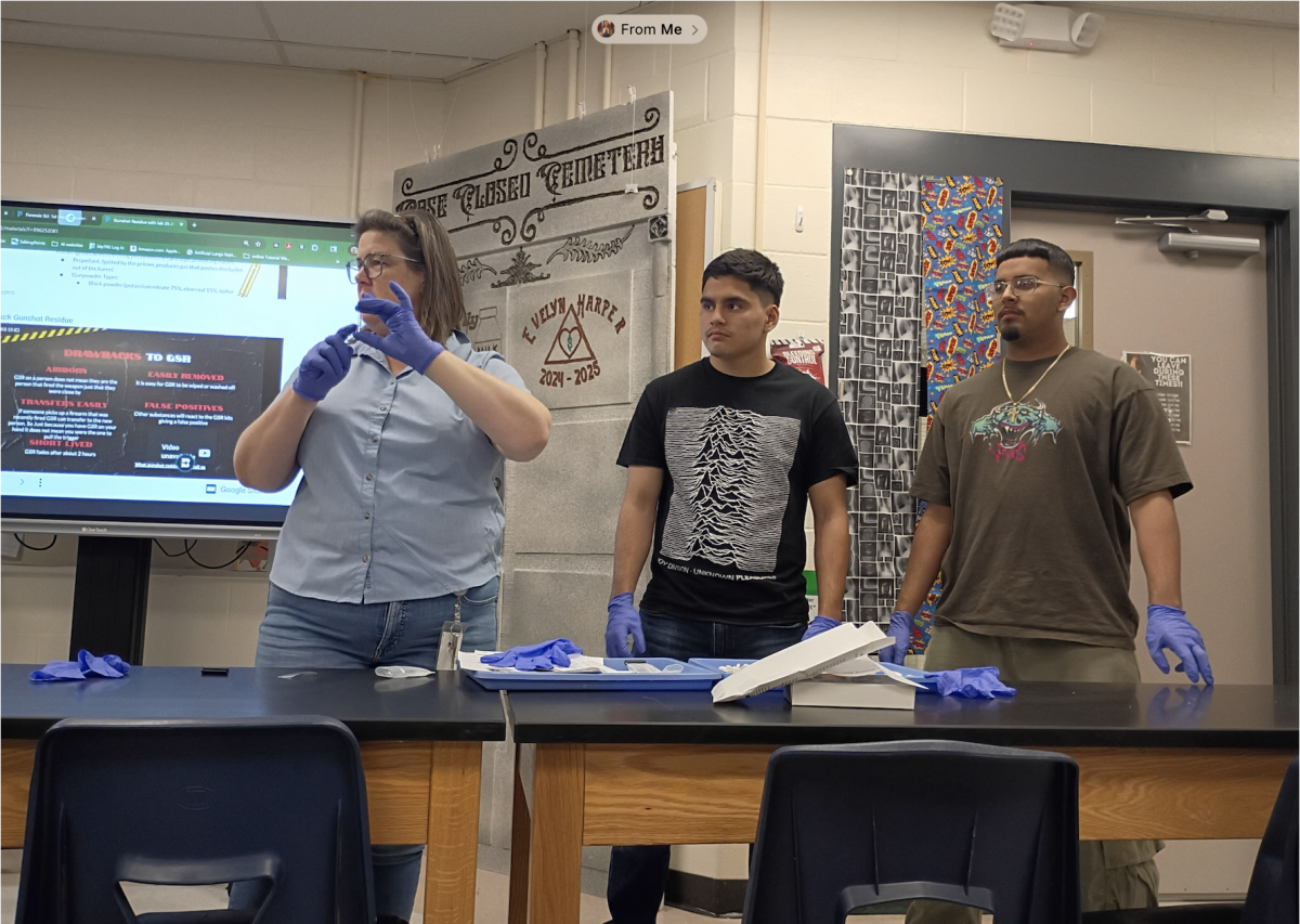 While demonstrating ballistics lab forensics teacher Carol Seng and seniors Julio Huitron and Markus Mares learn how to properly examine bullets and their casings. “I want students to know the steps needed to make firearms safe so that they don't accidently discharge and hurt someone,” Seng said. “And what investigators look for to catch the suspect.”
